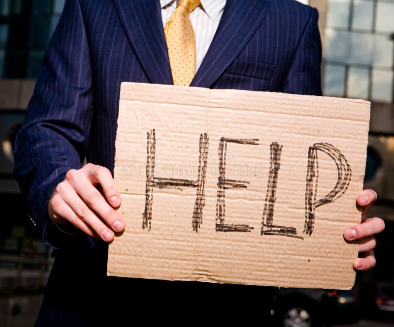 Businessman holding sign Help outdoors