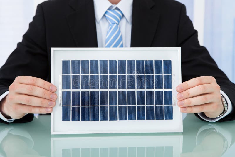 Businessman Holding Solar Panel at Office Desk Stock Image Image of desk, person 58561289