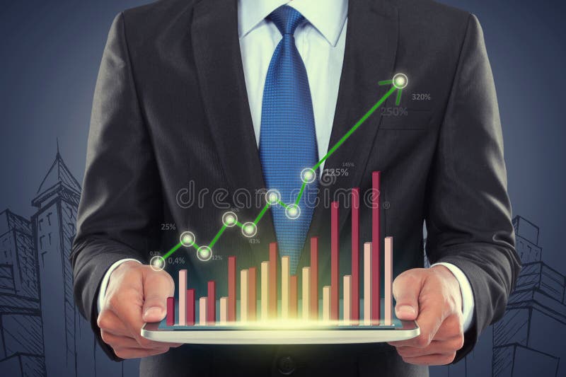 Businessman holding tablet pc with a graph stock images