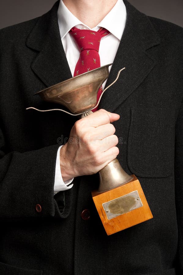 Businessman Holding a Trophy Stock Image - Image of antique, victory