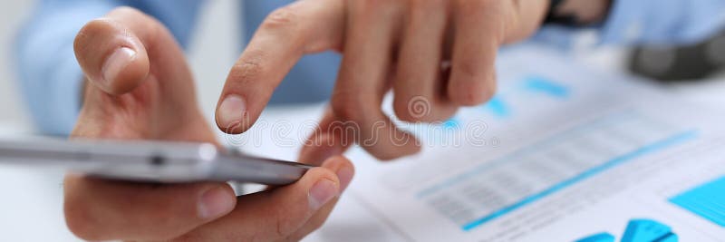 Businessman holds a new smartphone in his hand