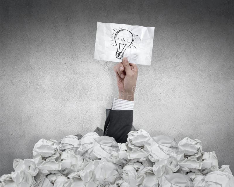 Businessman with an idea under crumpled paper