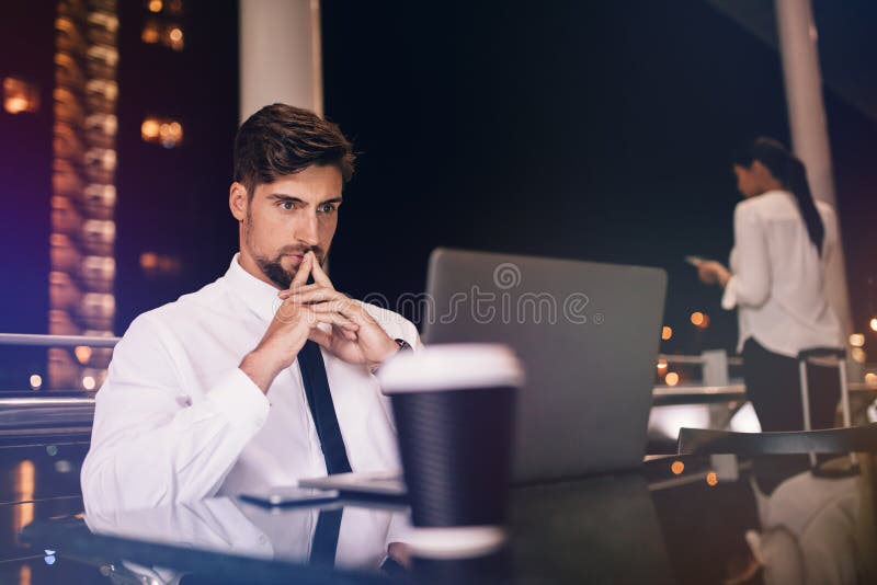 Businessman with laptop in modern airport lounge