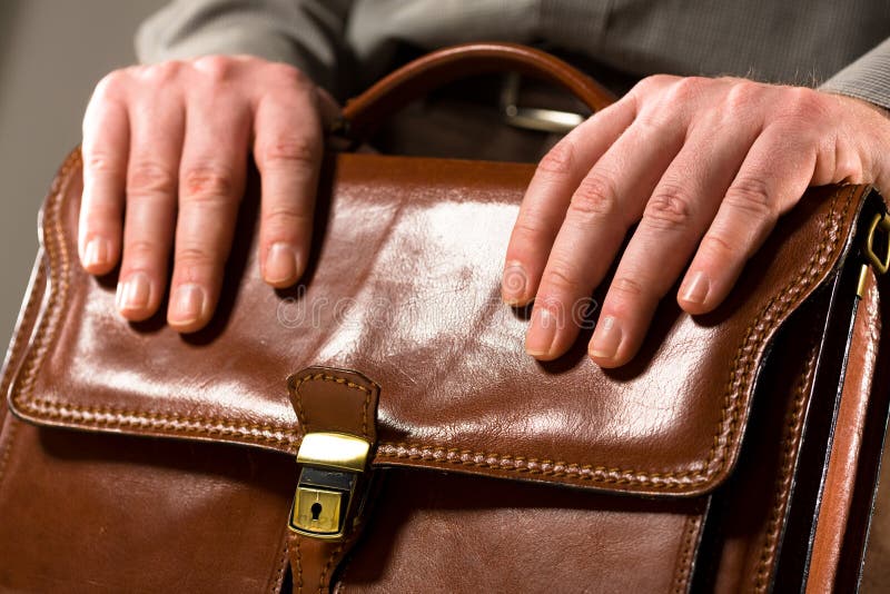 Business man holding elegant brown leather briefcase. Business man holding elegant brown leather briefcase.