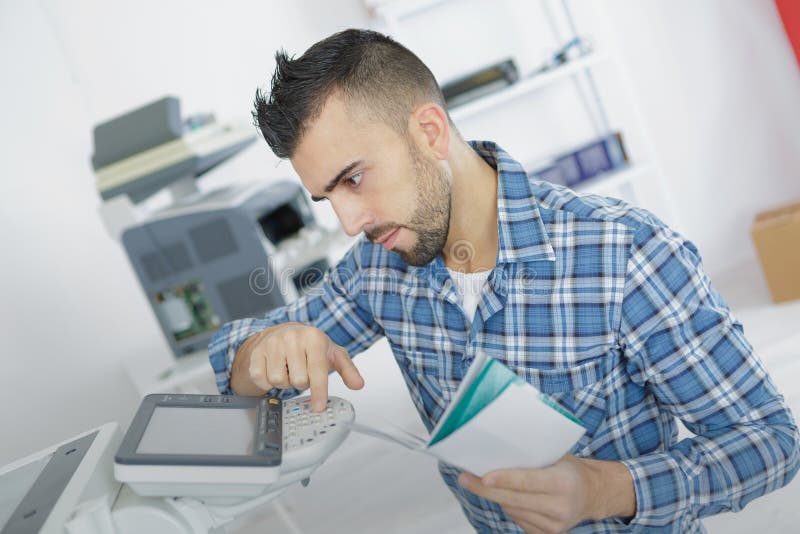 Businessman learning to use office printer stock photo