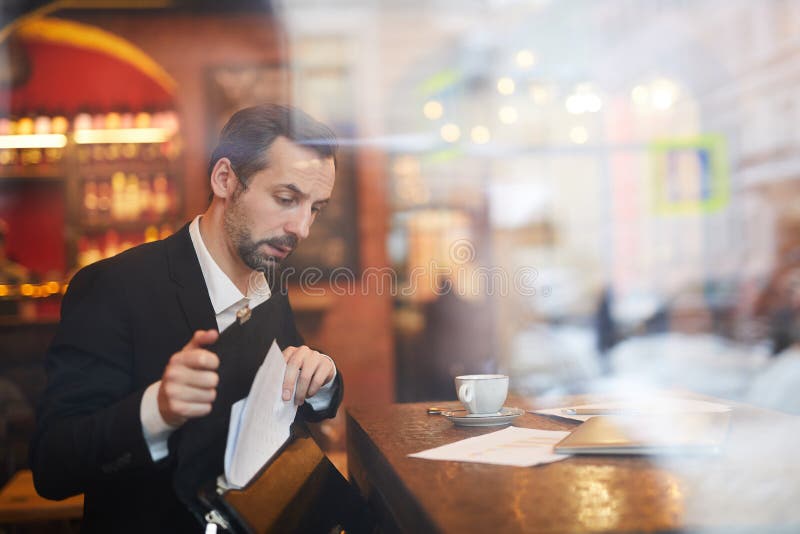 Businessman leaving Cafe stock image Businessman leaving Cafe stock image