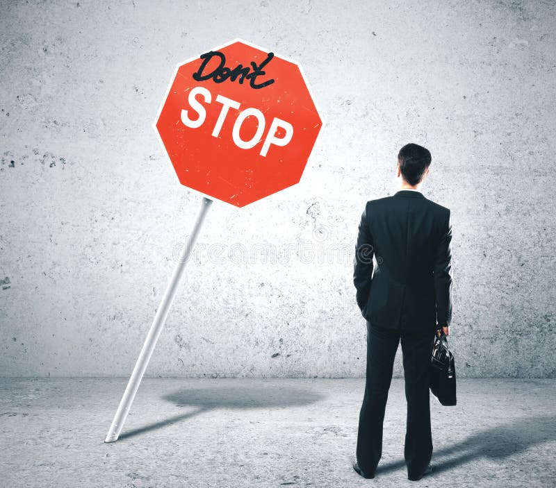Businessman looking on dont stop sign royalty free stock images Businessman looking on dont stop sign royalty free stock images