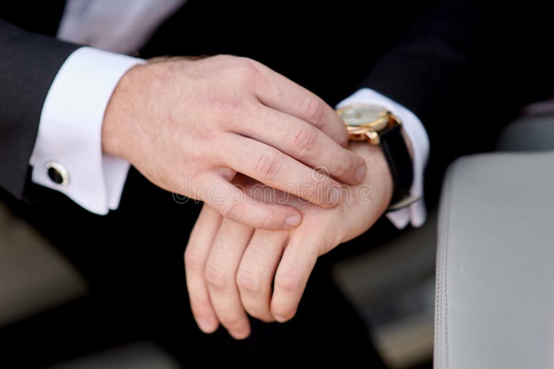 Businessman looking at his watch punctuality