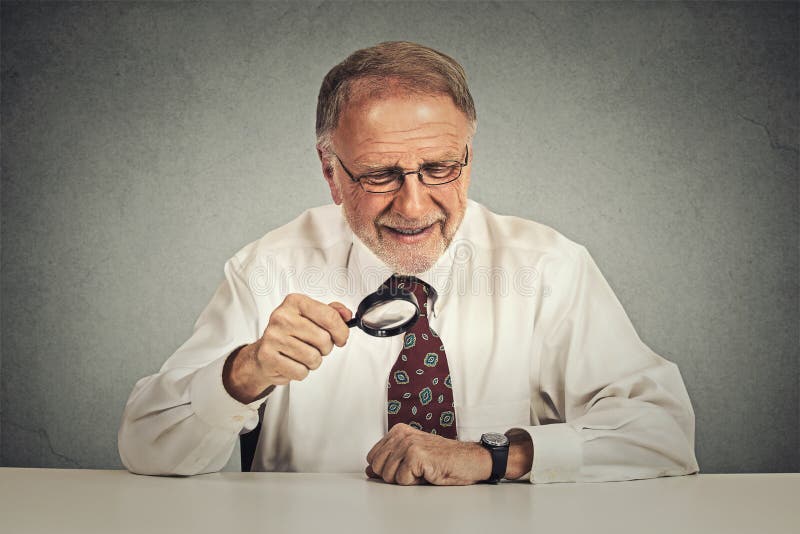 Businessman looking through a magnifying glass stock photos Businessman looking through a magnifying glass stock photos