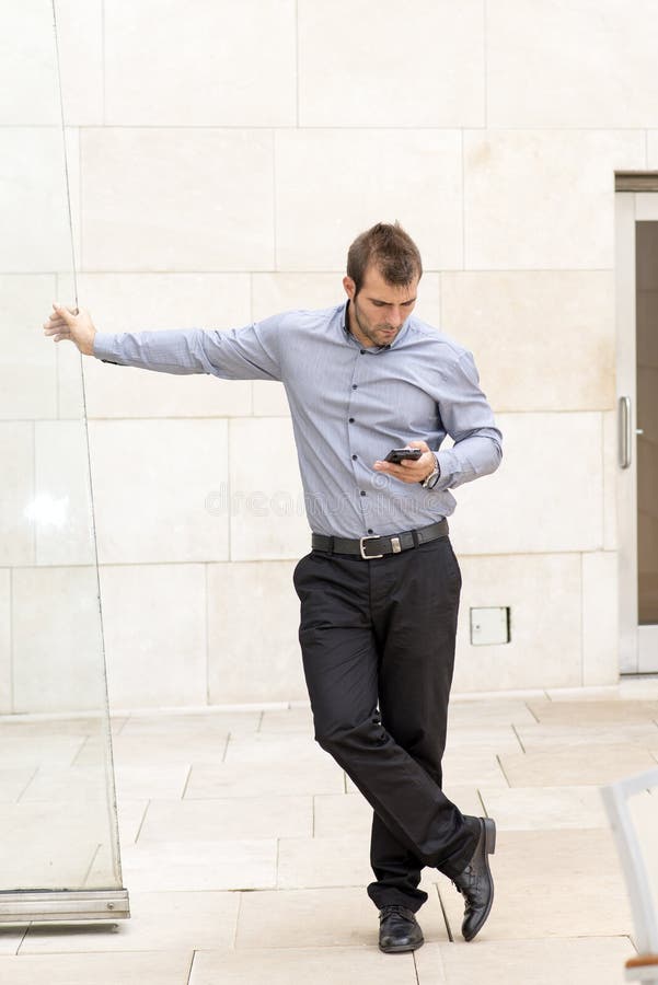 Businessman looking at messages in his smartphone.