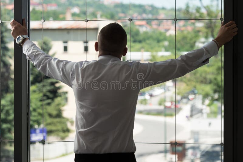 Businessman Looking Through Office Window