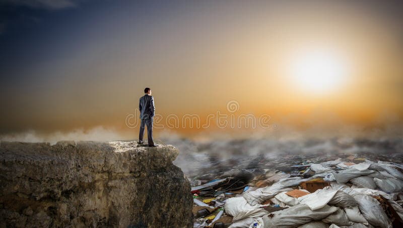 Businessman looks on piles of garbage, back view