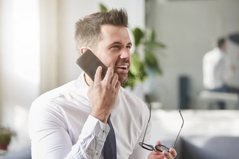 Businessman making a call while sitting in the office stock photography Businessman making a call while sitting in the office stock photography
