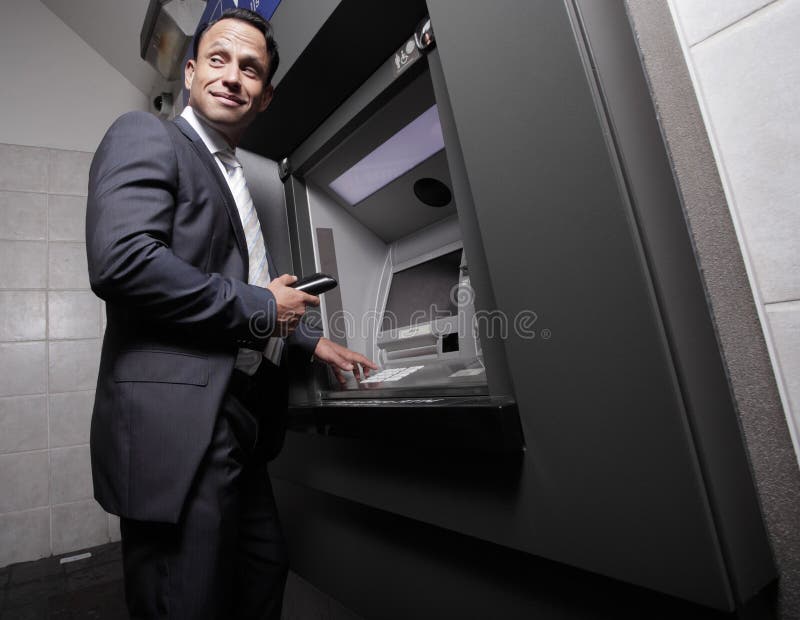 Businessman making a withdrawal royalty free stock photos Businessman making a withdrawal royalty free stock photos