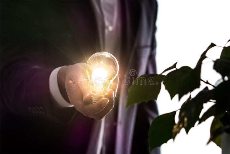Businessman or man in a suit holding a light bulb. royalty free stock photography Businessman or man in a suit holding a light bulb. royalty free stock photography