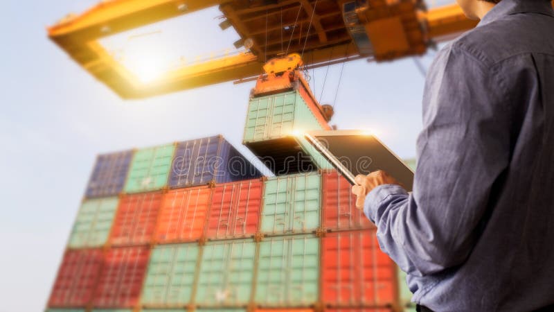 Business Logistics concept, Businessman manager using tablet check and control of Container Cargo ship with working crane bridge. Industry 4.0 concept