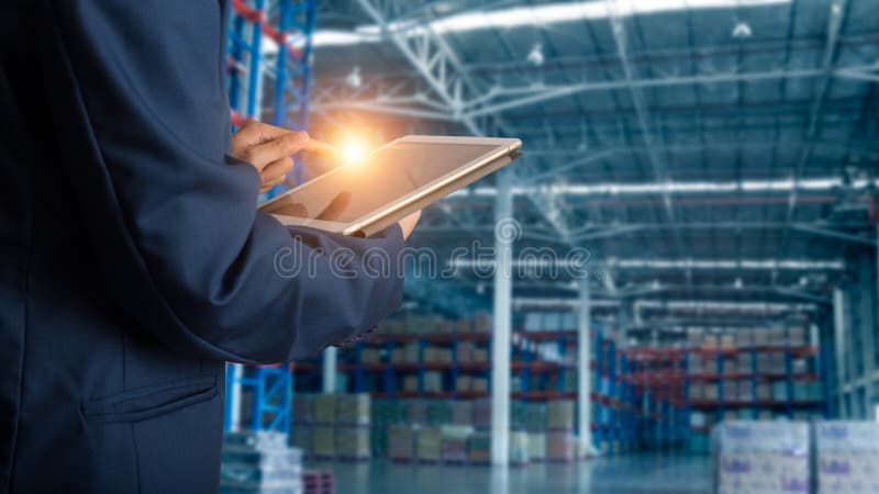 Businessman manager using tablet check and control for workers with Modern Trade warehouse logistics. Industry 4.0 concept,planning of logistics, Transportation within the country and Global