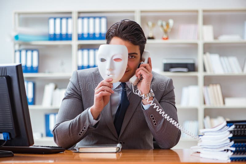 The businessman with mask in office hypocrisy concept