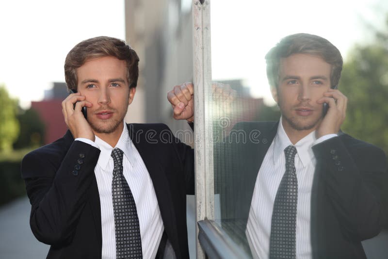 Businessman on mobile phone stock images