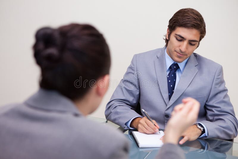 Businessman in negotiation taking notes stock images