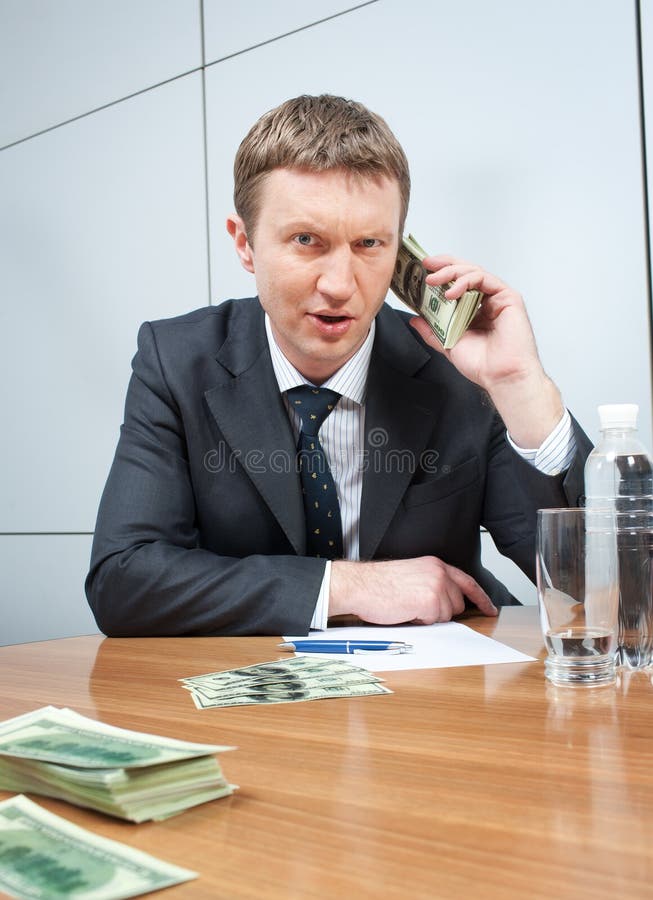 Businessman with pack of dollars