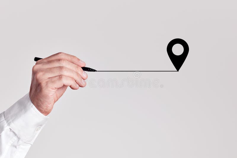 Businessman with a pen draws a line coming from the pin map location royalty free stock images