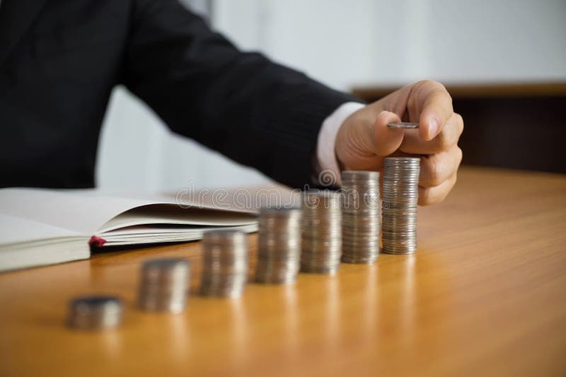 Businessman picks coins on the table, counts money . Business concept stock images Businessman picks coins on the table, counts money . Business concept stock images