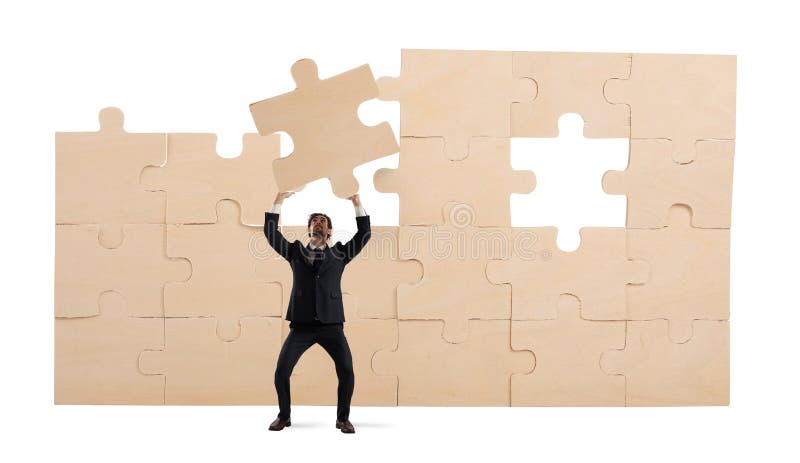 Businessman with a piece of puzzle. Build the business concept royalty free stock photo Businessman with a piece of puzzle. Build the business concept royalty free stock photo