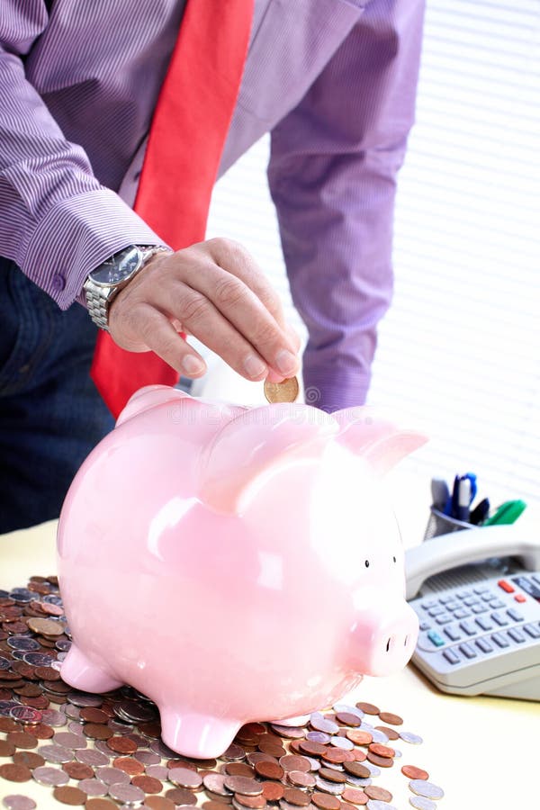 Businessman with a pig bank