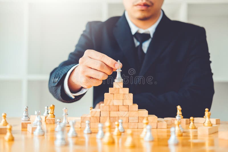 Businessman playing chess game Planning of leading strategy successful business leader concept