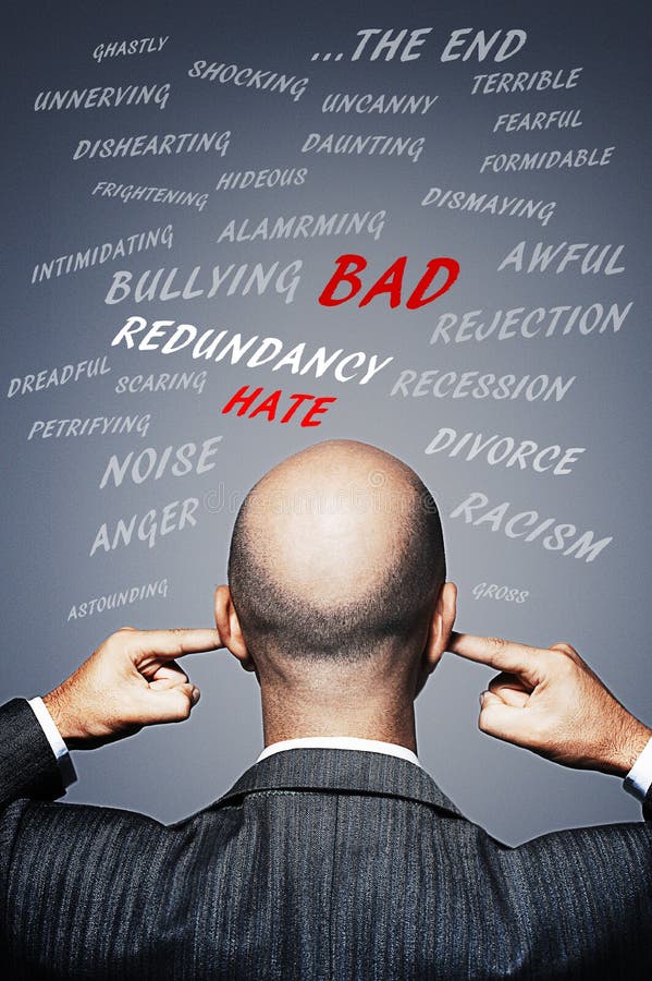 Businessman plugging his ears to avoid negative words and energy