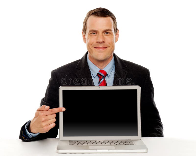 Businessman pointing at blank laptop screen stock photo Businessman pointing at blank laptop screen stock photo
