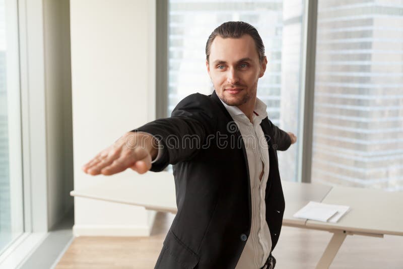 Businessman practices yoga in office for wellness royalty free stock image Businessman practices yoga in office for wellness royalty free stock image