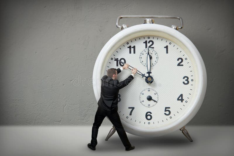 Businessman pulling a clock hand