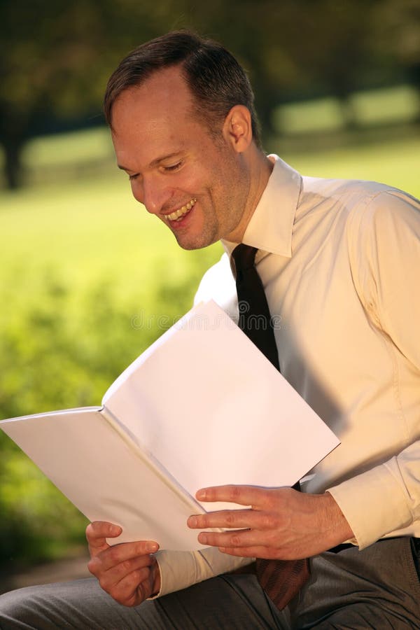 Businessman reading magazine