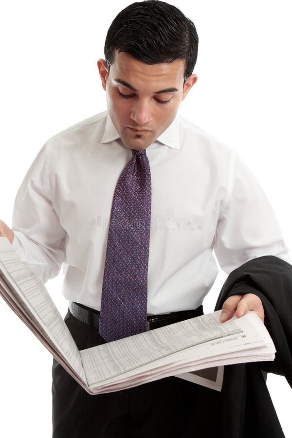 Businessman reads share prices in newspaper