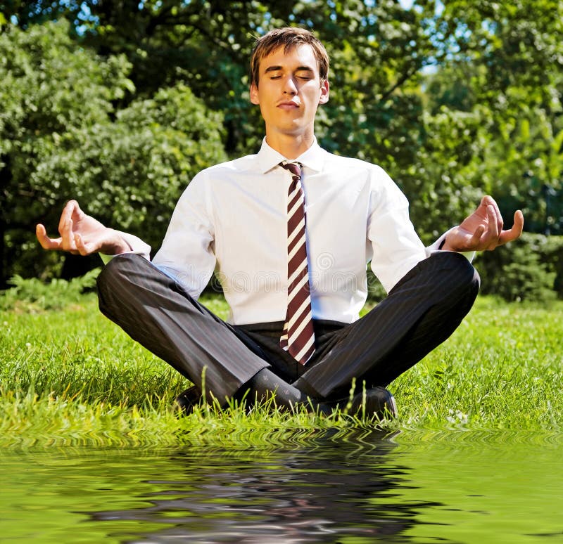 Businessman relaxing on the grassland