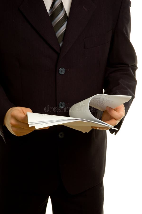 Standing businessman reviewing documents before the meeting starts. Standing file folder stock images, royalty-free photos and pictures