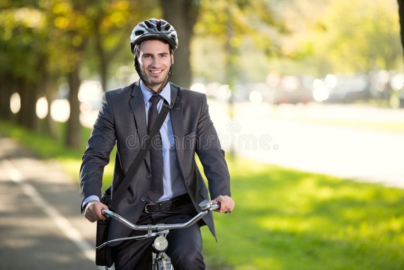 Businessman riding a bicycle to work, concept gas savings conce stock photography Businessman riding a bicycle to work, concept gas savings conce stock photography