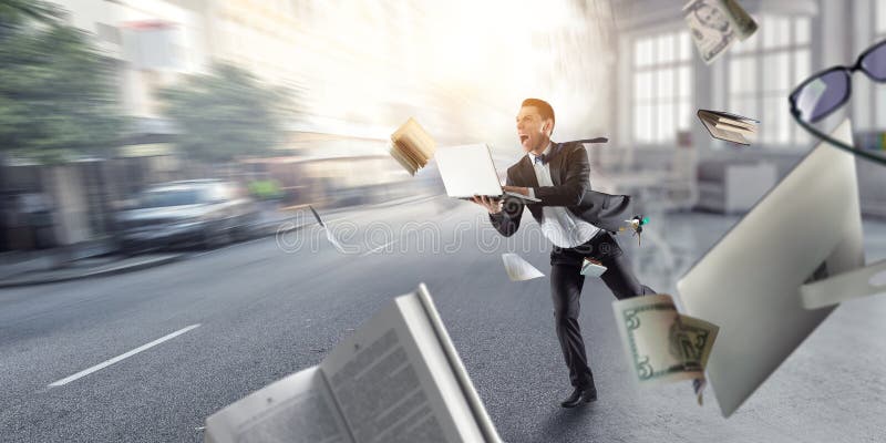 Businessman running among chaos. Mixed media content royalty free stock photo