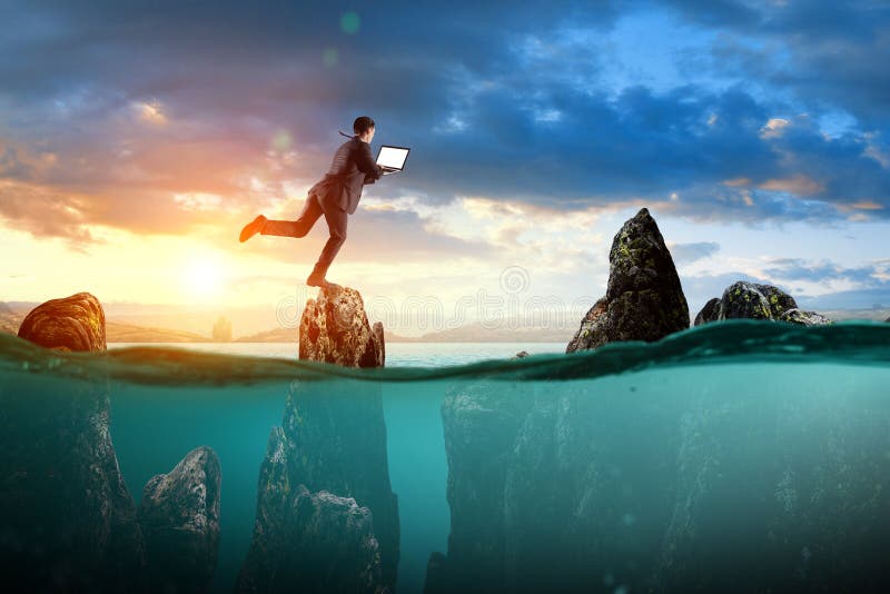 Businessman running on top of the underwater rock mountains stock photography