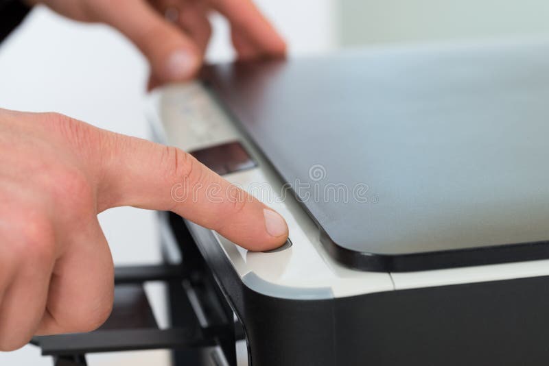 Businessman's finger pressing button of photocopy machine royalty free stock photography