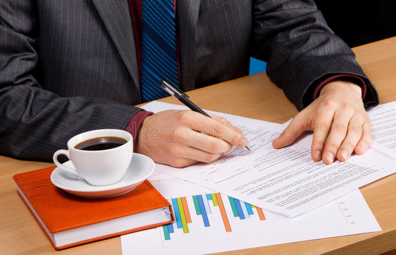 Businessman s table covered with documents