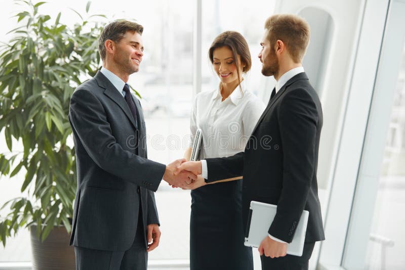 Businessman shaking hands. People shake hands communicating with stock image