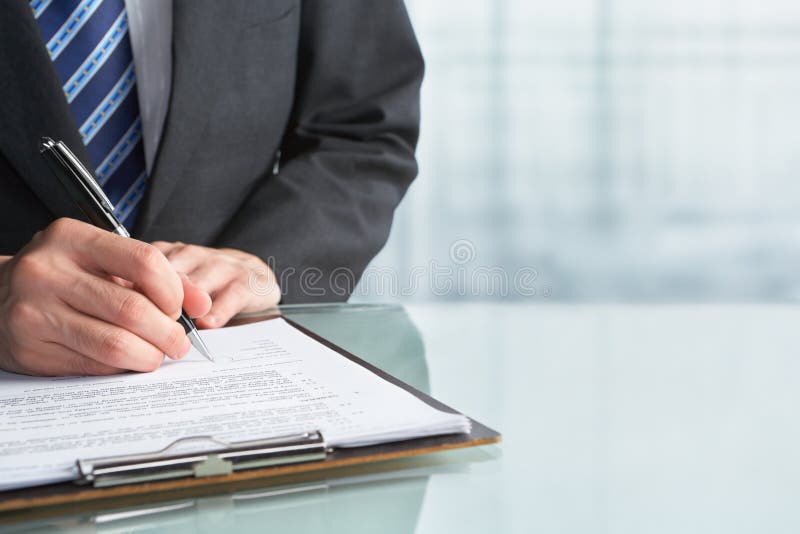 Businessman signing contract stock image