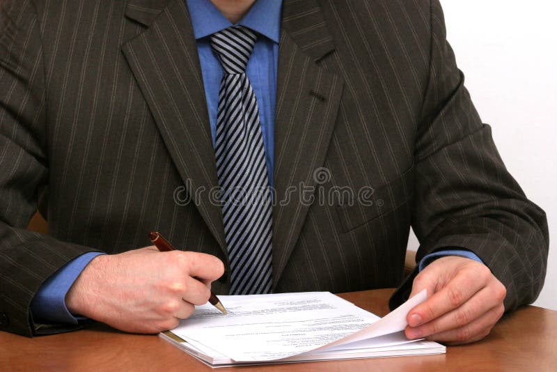 Businessman is signing a document stock photo Businessman is signing a document stock photo