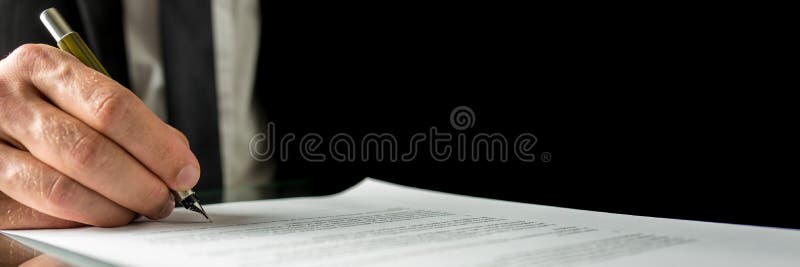 Businessman signing a document stock photo