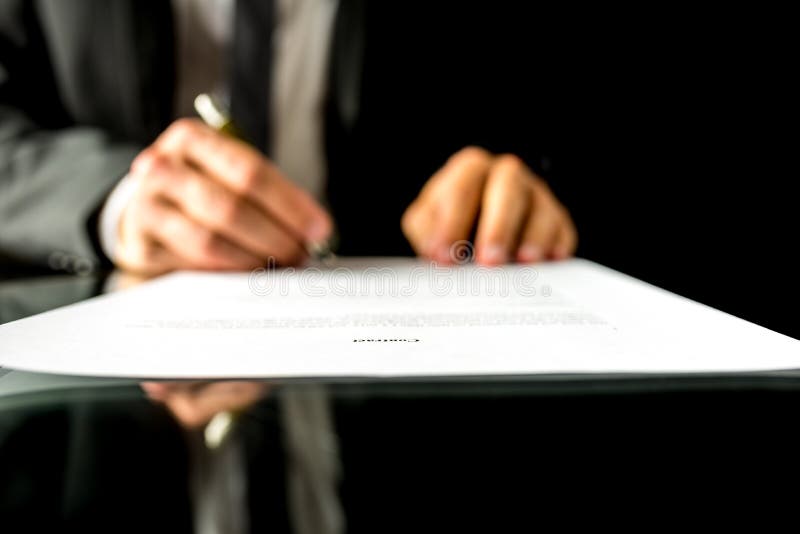 Businessman signing a document with focus to the text Contract stock photo