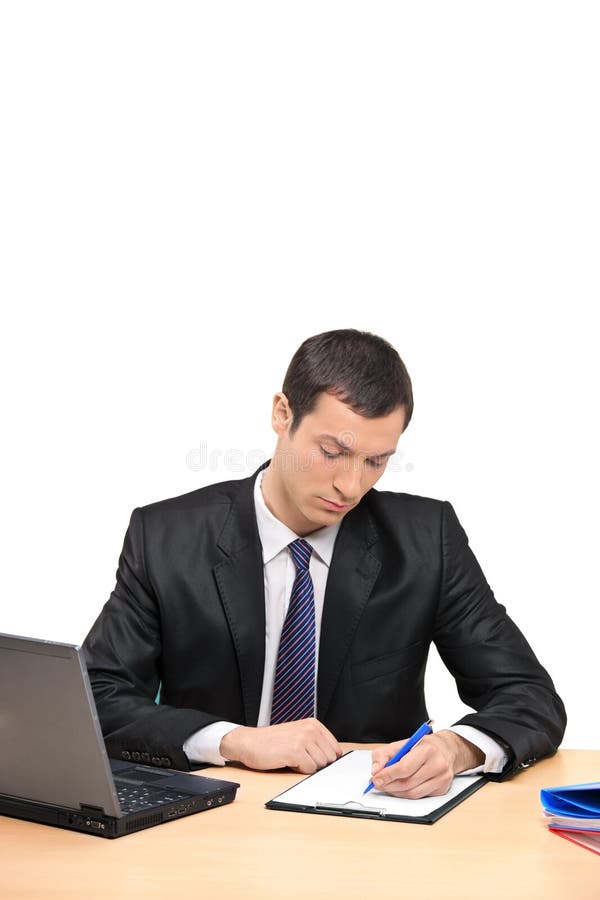 Businessman signing a document in the office stock images
