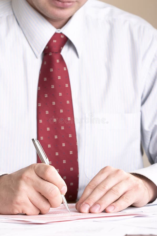 Businessman signing documents stock photos